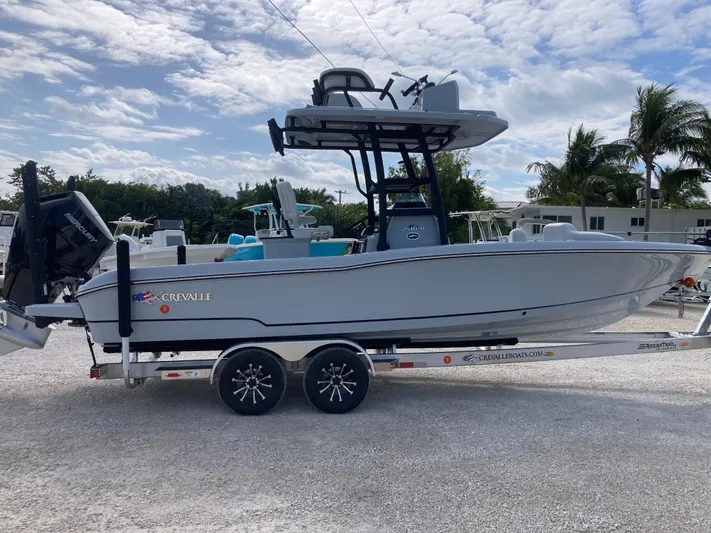  Yacht Photos Pics 2025 Crevalle 26HCO boat on trailer, parked outdoors under a partly cloudy sky.