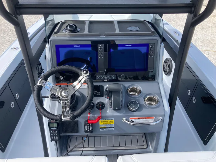  Yacht Photos Pics 2025 Crevalle 26HCO boat dashboard with dual screens and steering wheel.