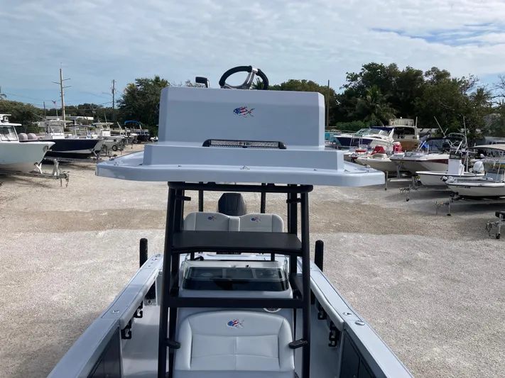  Yacht Photos Pics 2025 Crevalle 26HCO boat in a marina, showcasing helm and seating area.