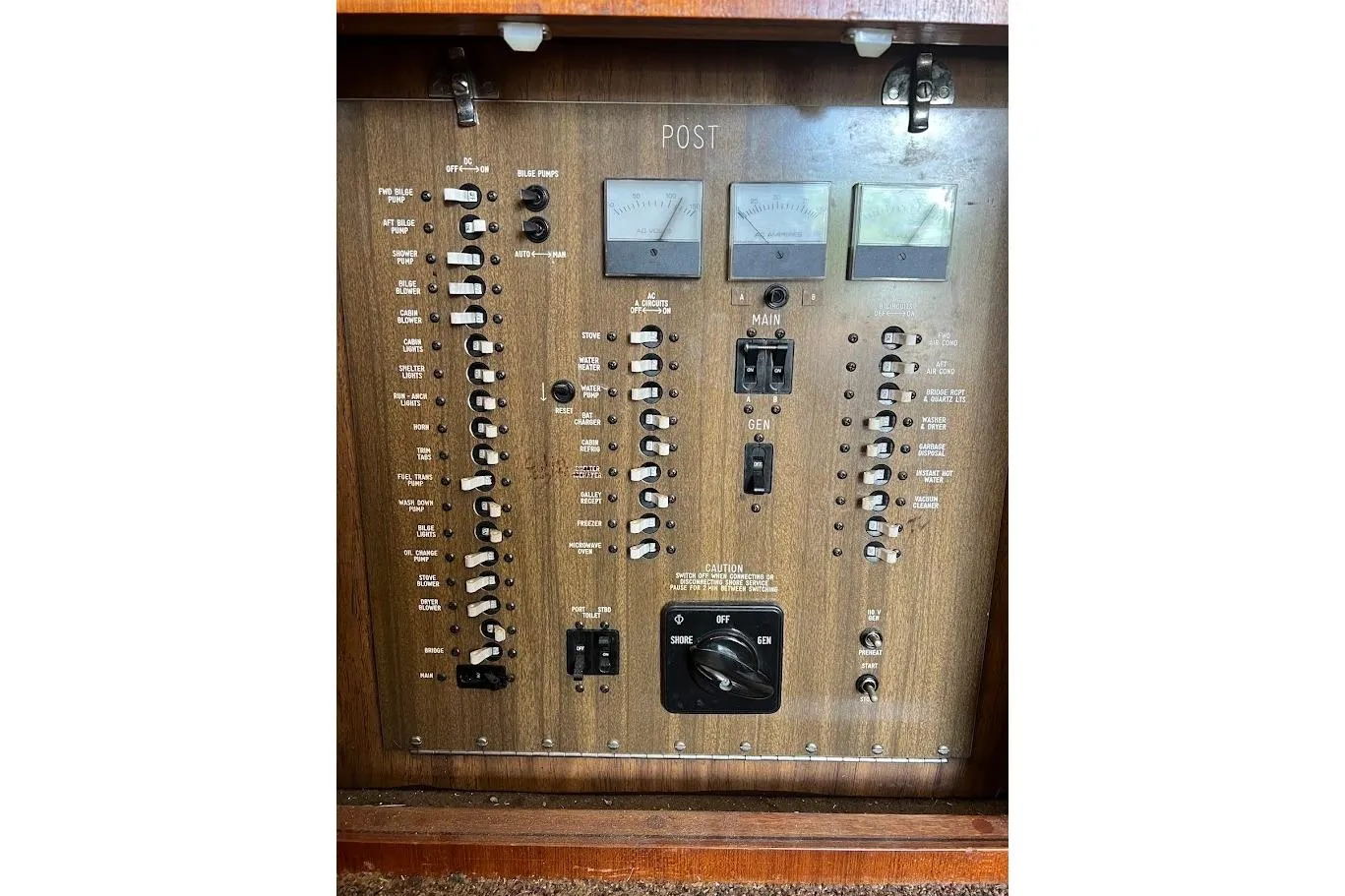 Electrical control panel of a 1988 Post 46 ll boat with switches and gauges.