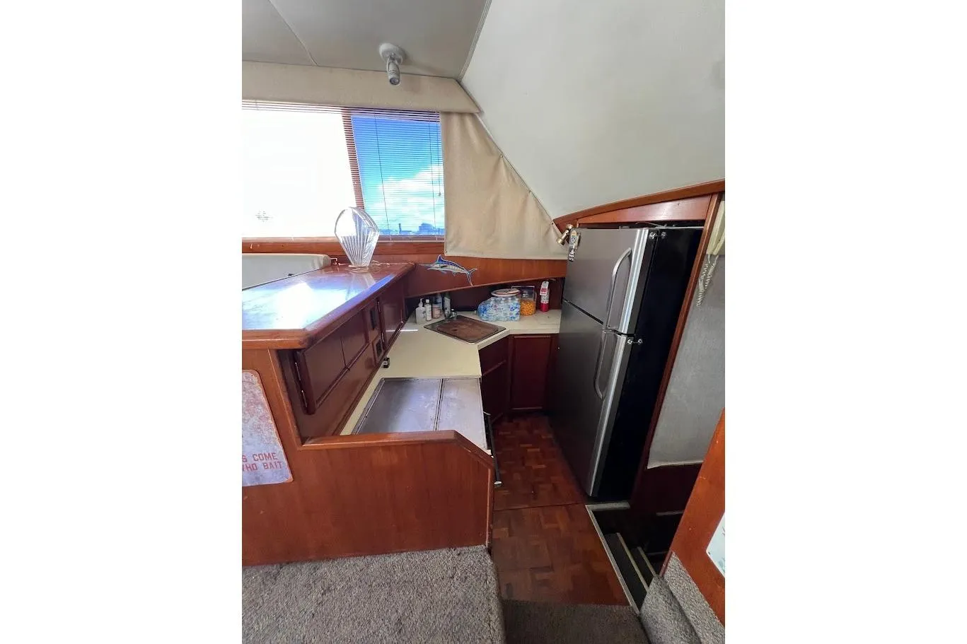 1988 Post 46 ll yacht interior kitchen with wood cabinetry and modern appliances.