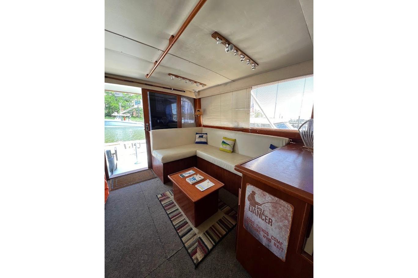 Interior of 1988 Post 46 ll yacht with cozy seating and nautical decor.