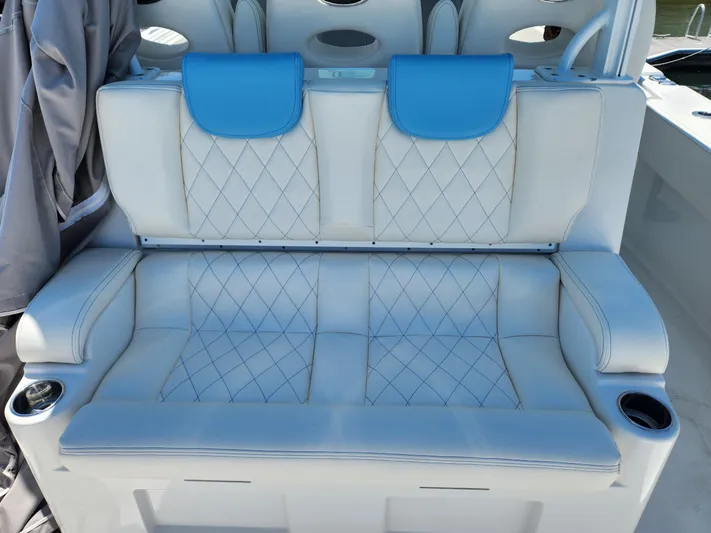 Triple J Yacht Photos Pics Luxurious seating on 2018 HCB 39 Speciale boat with blue accents and cup holders.