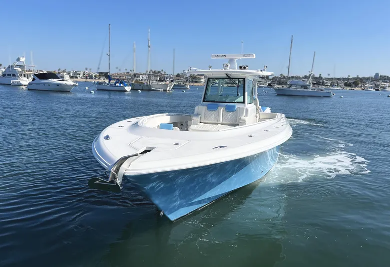 Triple J Yacht Photos Pics 2018 HCB 39 Speciale boat cruising in a marina with clear blue skies.