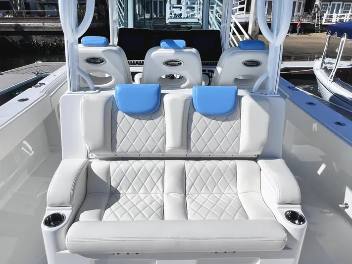 Triple J Yacht Photos Pics Luxury seating on 2018 HCB 39 Speciale boat with blue accents and cup holders.