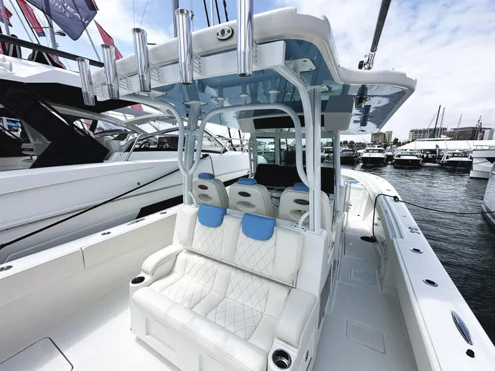 Triple J Yacht Photos Pics 2018 HCB 39 Speciale boat with luxurious seating and sleek design at a marina.