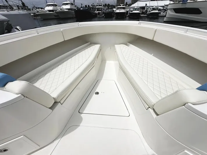 Triple J Yacht Photos Pics 2018 HCB 39 Speciale boat interior with white cushioned seating and diamond stitching.