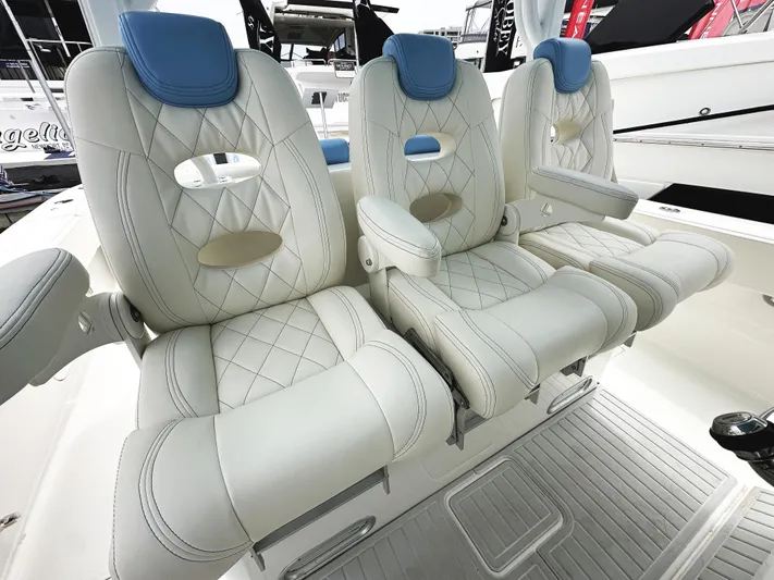 Triple J Yacht Photos Pics Luxurious seating on 2018 HCB 39 Speciale boat with quilted upholstery and armrests.
