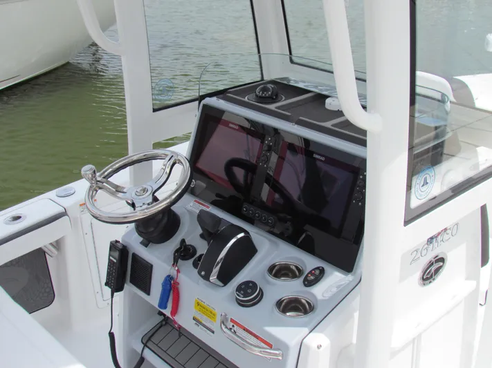 Model Year Clearance Yacht Photos Pics 2024 Crevalle 26 HCO boat console with steering wheel and navigation equipment.