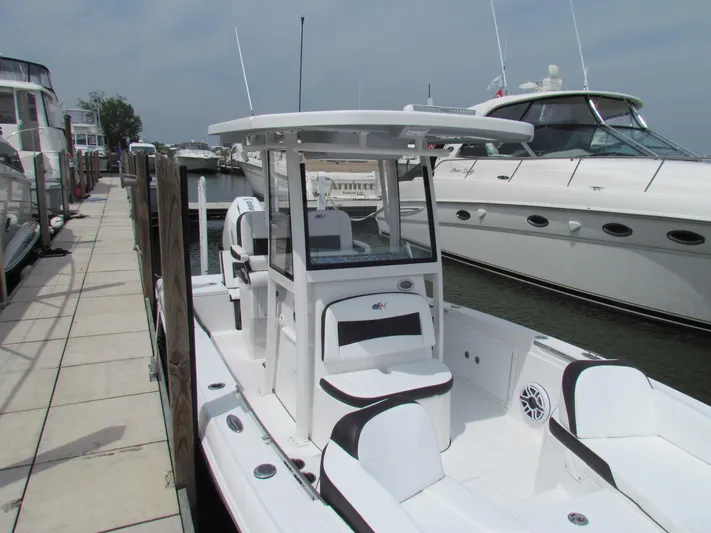 Model Year Clearance Yacht Photos Pics 2024 Crevalle 26 HCO boat docked, featuring sleek design and spacious seating.