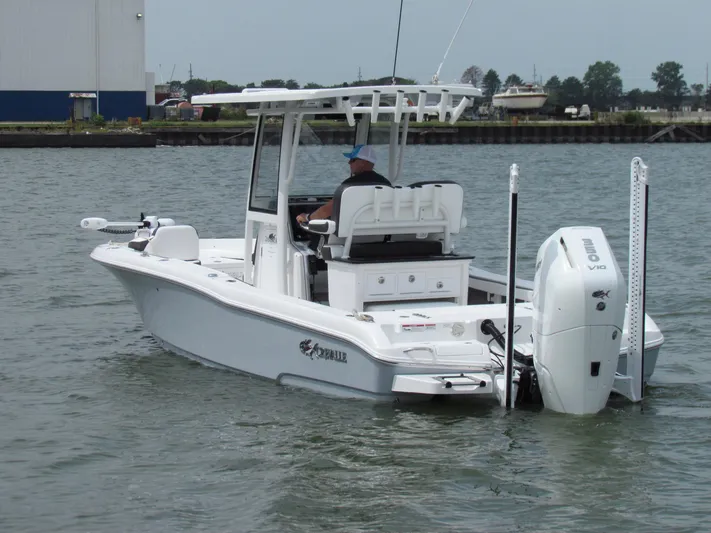 Model Year Clearance Yacht Photos Pics 2024 Crevalle 26 HCO boat on water, featuring sleek design and powerful outboard engine.
