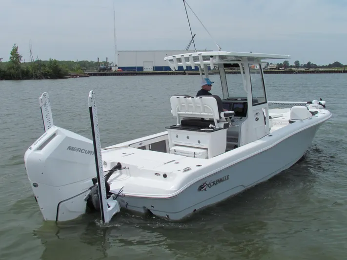 Model Year Clearance Yacht Photos Pics 2024 Crevalle 26 HCO boat on water, featuring a Mercury engine and sleek design.