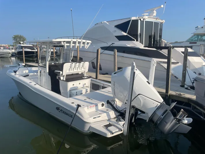 Model Year Clearance Yacht Photos Pics 2024 Crevalle 26 HCO boat docked at marina, featuring sleek design and powerful outboard motor.