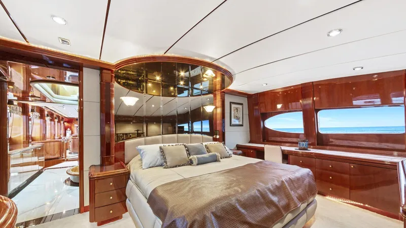 Destiny Yacht Photos Pics Luxurious yacht bedroom with elegant wood paneling and ocean view windows, Destiny 98', 2001 model.