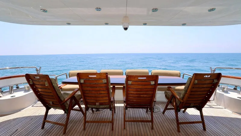 Destiny Yacht Photos Pics Luxury yacht deck with wooden chairs overlooking the ocean, Destiny 98', 2001 model.