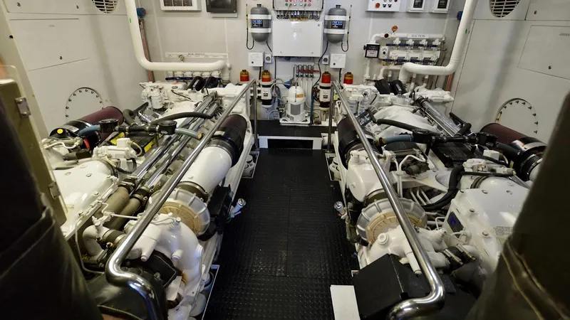 Destiny Yacht Photos Pics Engine room of a 2001 Destiny 98' yacht, featuring dual engines and control systems.