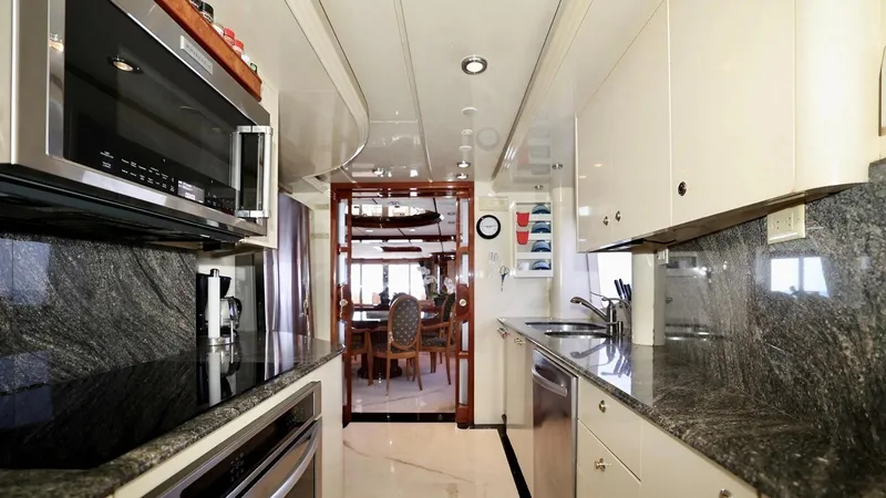Destiny Yacht Photos Pics Luxurious yacht kitchen with granite countertops, modern appliances, and elegant dining area. Destiny 98', 2001.