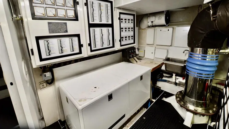 Destiny Yacht Photos Pics Engine room of a 2001 Destiny 98' yacht with control panels and equipment.