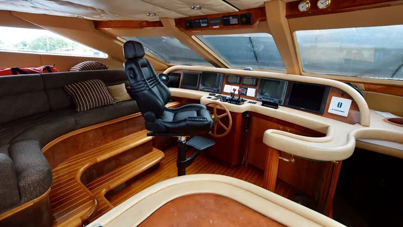 Destiny Yacht Photos Pics Luxurious yacht interior with leather captain's chair, wooden accents, and navigation equipment, Destiny 98', 2001.