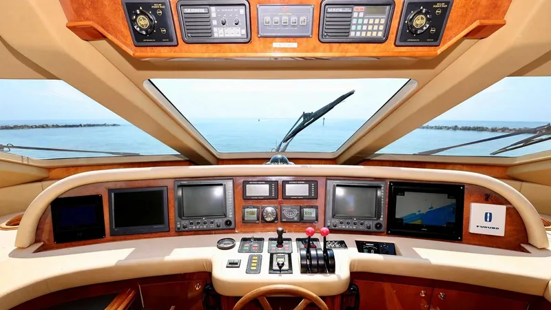 Destiny Yacht Photos Pics Luxury yacht cockpit with navigation instruments, Destiny 98', 2001 model, ocean view through windshield.