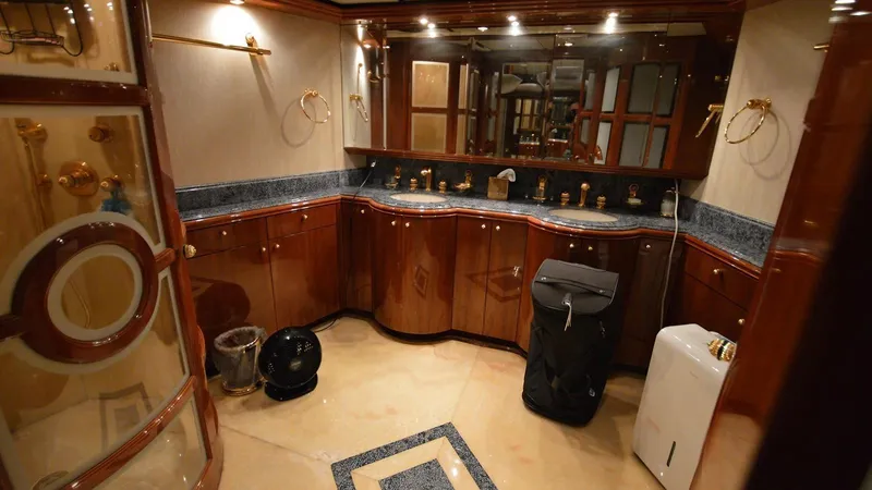 Destiny Yacht Photos Pics Luxurious yacht bathroom with wooden cabinetry, dual sinks, and elegant fixtures, Destiny 98', 2001 model.