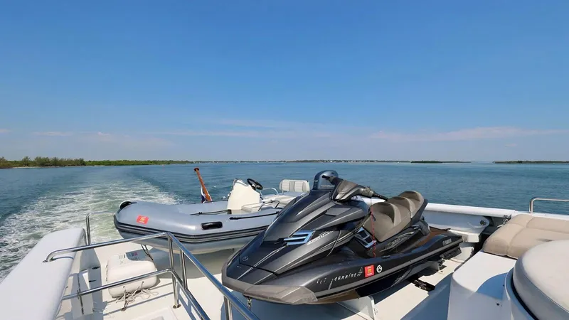 Destiny Yacht Photos Pics Jet ski and inflatable boat on Destiny 98' yacht, 2001, cruising on open water.