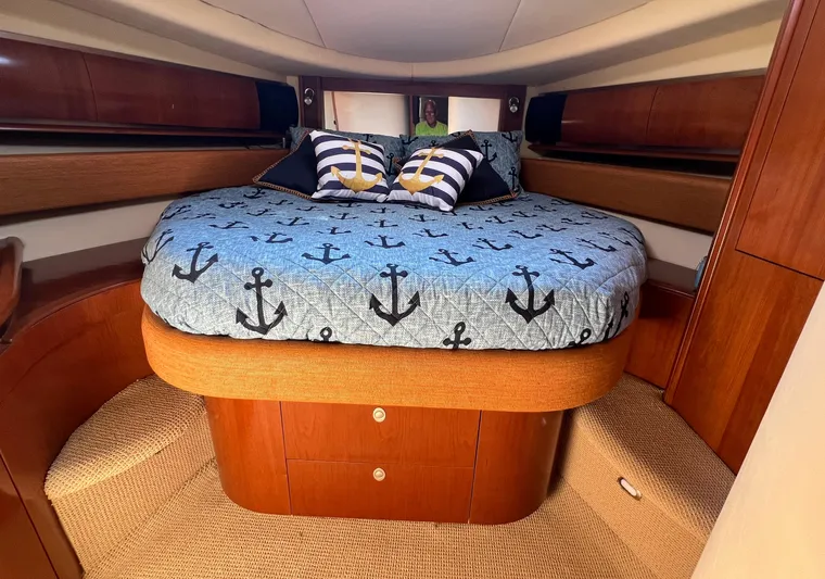 Decompressing Yacht Photos Pics Luxurious cabin interior of 2005 Sea Ray 500 Sundancer with anchor-themed bedding.