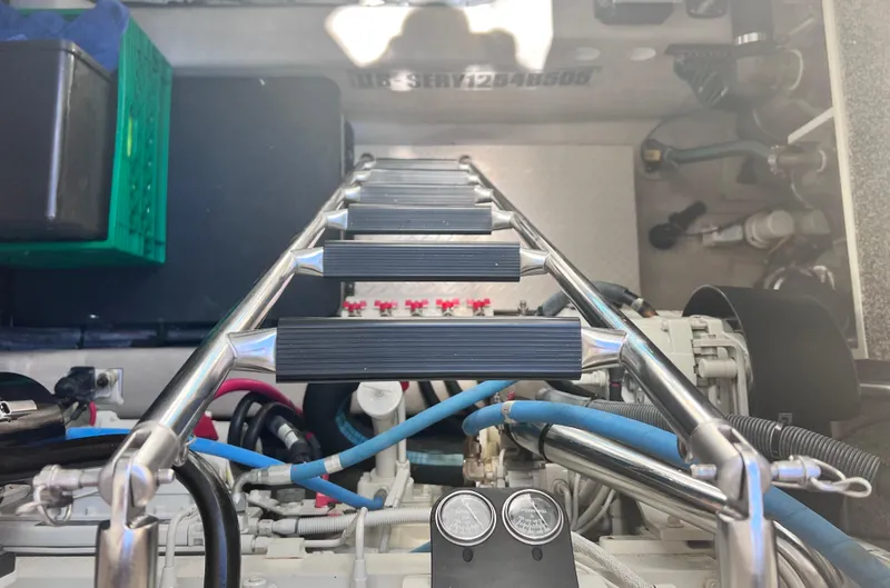 Decompressing Yacht Photos Pics Engine room of 2005 Sea Ray 500 Sundancer with ladder and mechanical components.