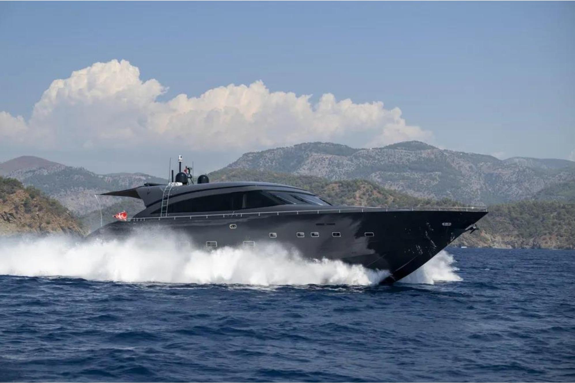Luxury yacht AB 92 (2006) cruising on open sea with scenic mountain backdrop.