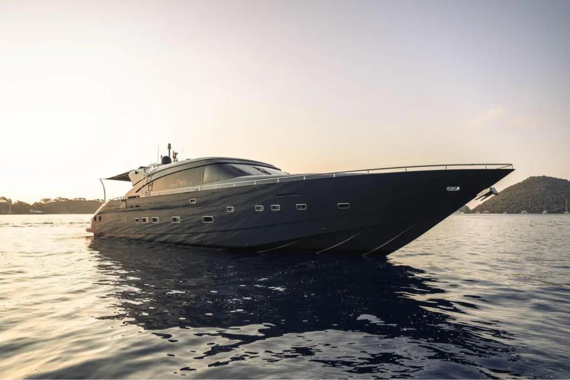 Luxurious 2006 AB 92 yacht cruising at sunset on calm waters.