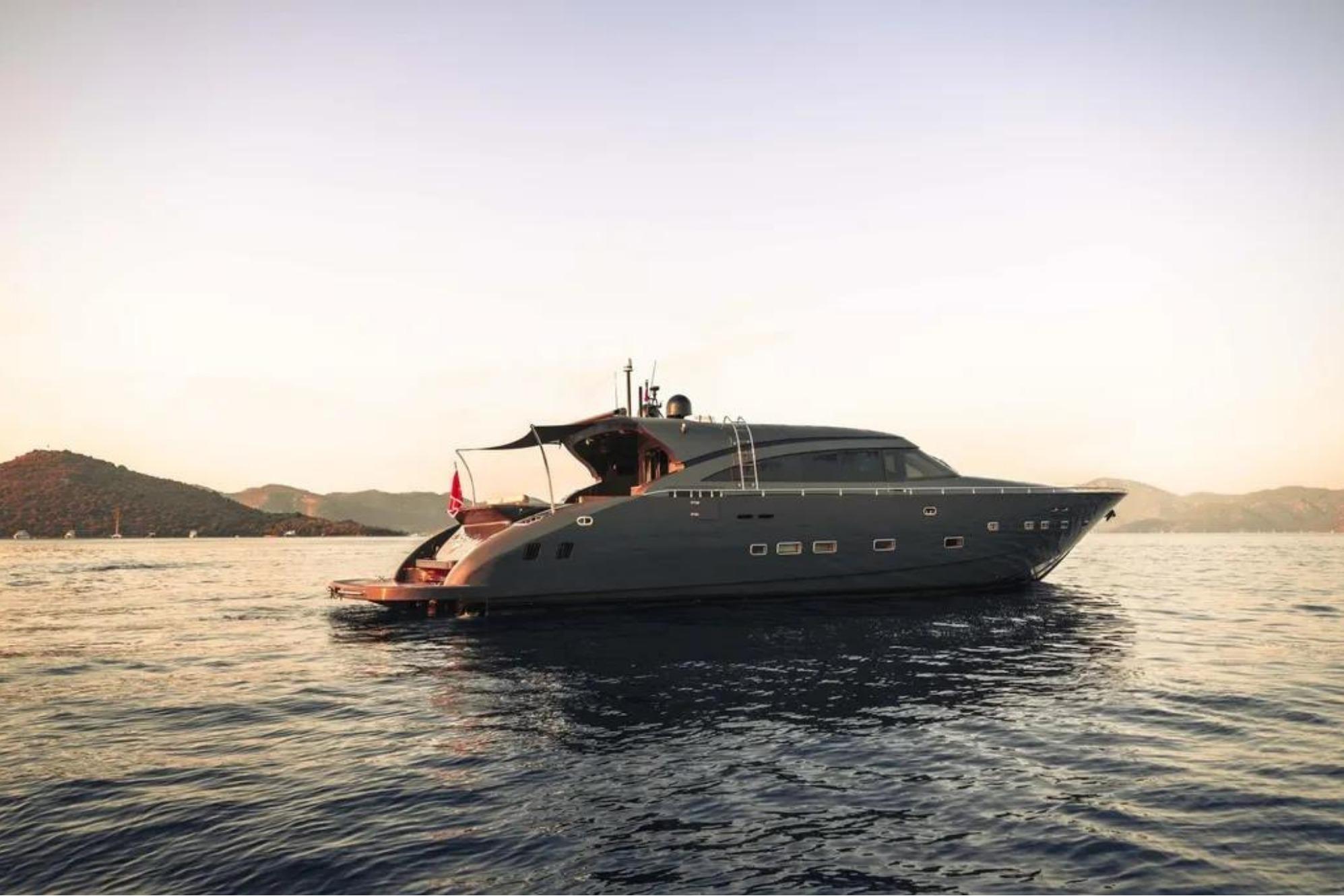Luxurious 2006 AB 92 yacht cruising at sunset on serene waters.