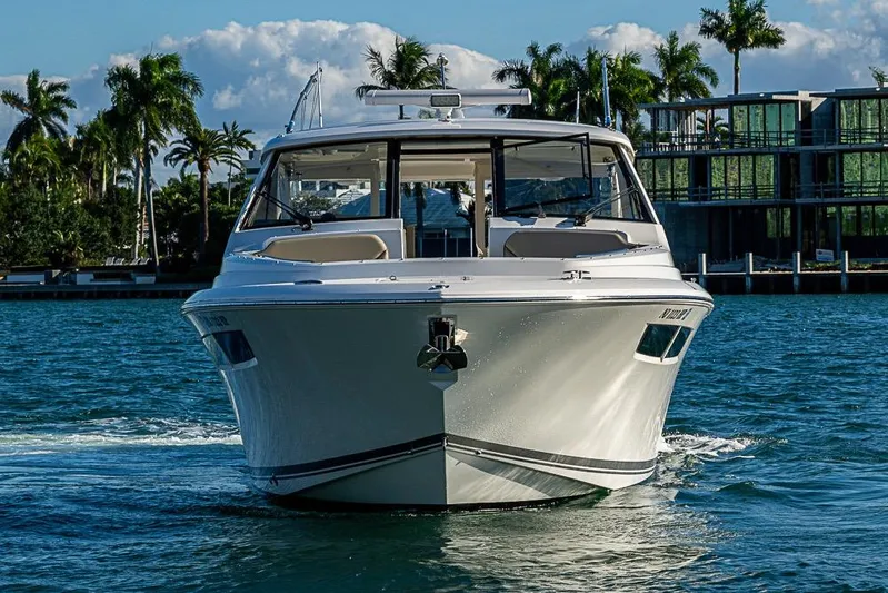  Yacht Photos Pics 2020 Pursuit DC 365 Dual Console boat cruising on a sunny day.