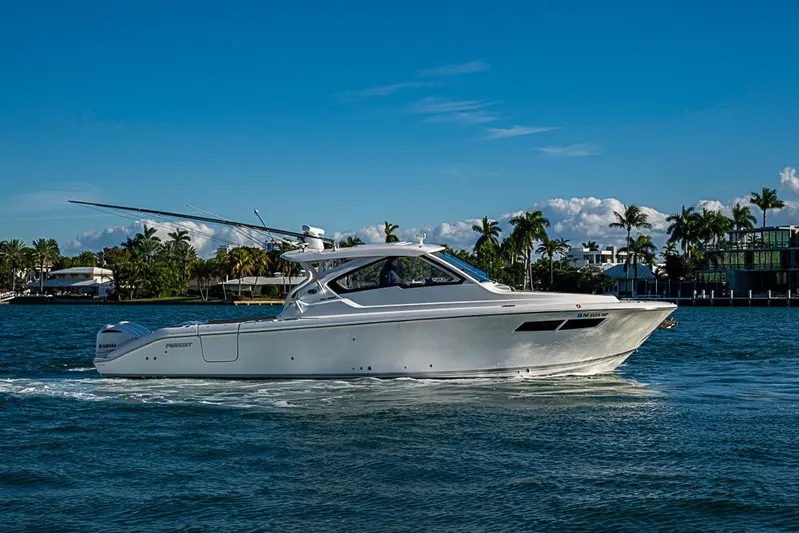  Yacht Photos Pics 2020 Pursuit DC 365 Dual Console boat cruising on a sunny day.