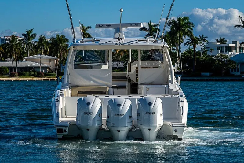  Yacht Photos Pics 2020 Pursuit DC 365 Dual Console boat with triple Yamaha engines on water.