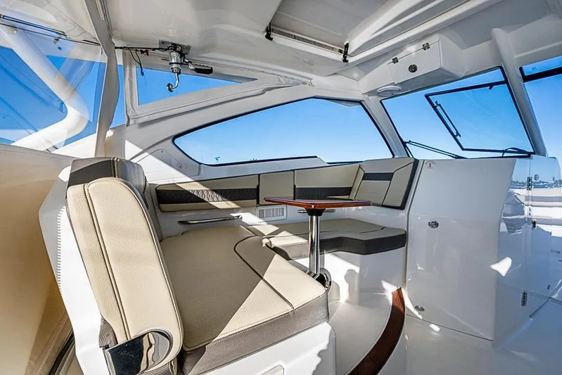  Yacht Photos Pics 2020 Pursuit DC 365 Dual Console interior with seating and table, showcasing luxury design.