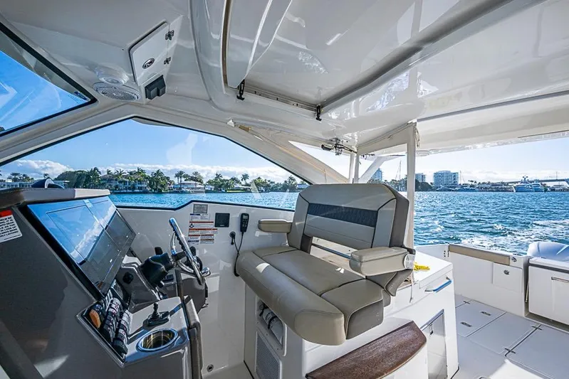  Yacht Photos Pics 2020 Pursuit DC 365 Dual Console interior with helm, seating, and ocean view.