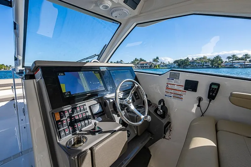  Yacht Photos Pics 2020 Pursuit DC 365 Dual Console helm with navigation screens and waterfront view.