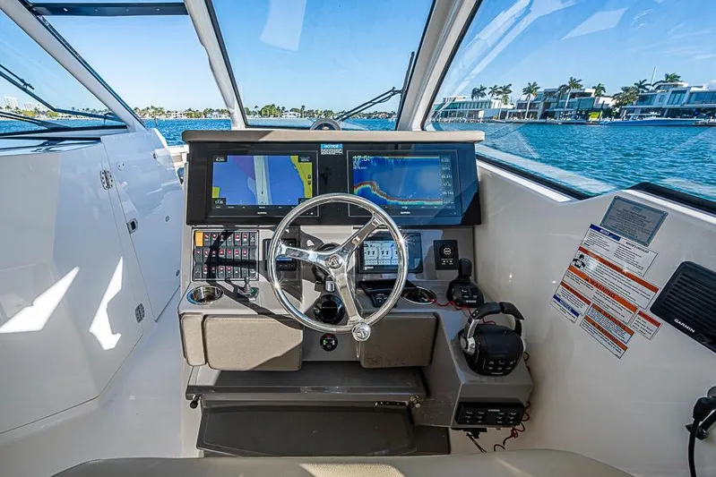  Yacht Photos Pics 2020 Pursuit DC 365 Dual Console helm with navigation screens and steering wheel.