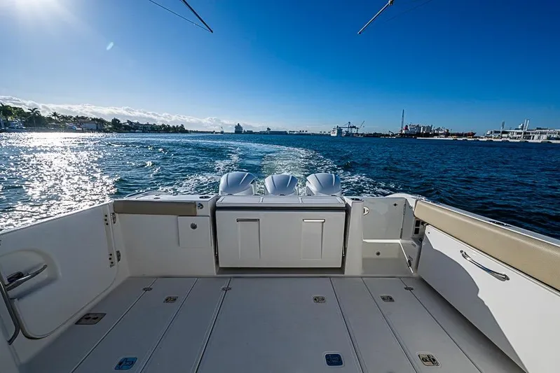  Yacht Photos Pics 2020 Pursuit DC 365 Dual Console boat cruising on sunny waters.