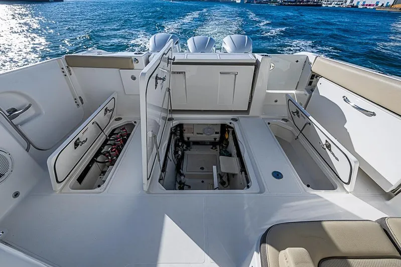  Yacht Photos Pics 2020 Pursuit DC 365 Dual Console boat interior with open storage compartments.