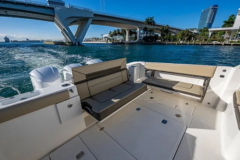  Yacht Photos Pics 2020 Pursuit DC 365 Dual Console boat on water near a bridge, sunny day.
