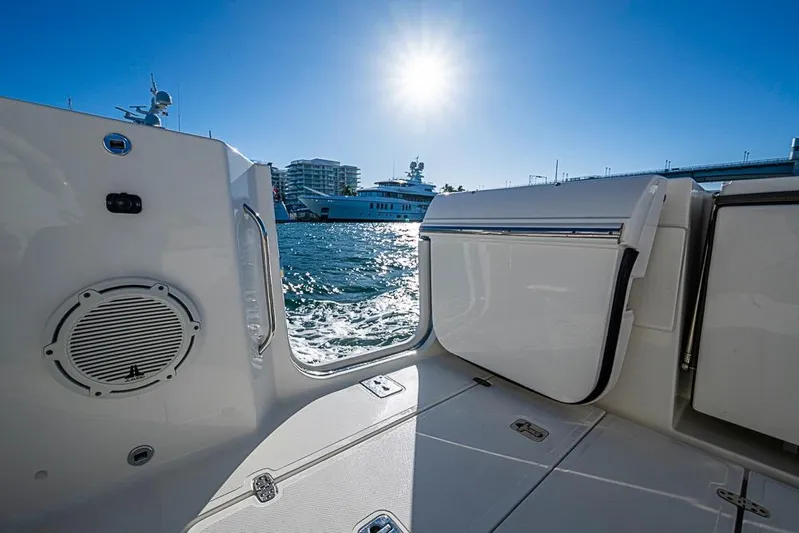  Yacht Photos Pics 2020 Pursuit DC 365 Dual Console boat interior with ocean view and bright sun.