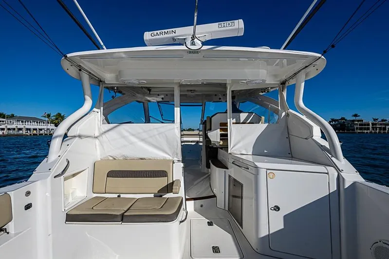  Yacht Photos Pics 2020 Pursuit DC 365 Dual Console boat interior with seating and storage, on a sunny day.