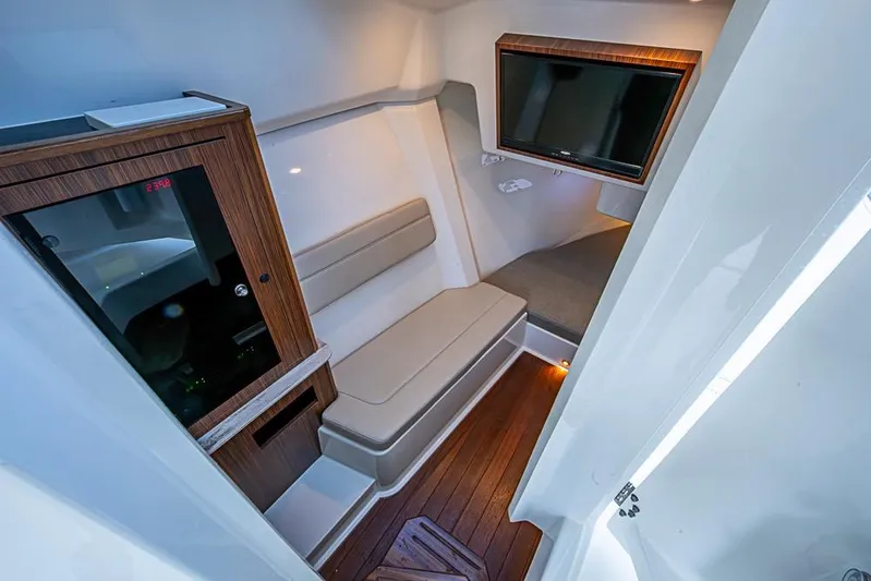  Yacht Photos Pics 2020 Pursuit DC 365 Dual Console cabin interior with seating and TV.