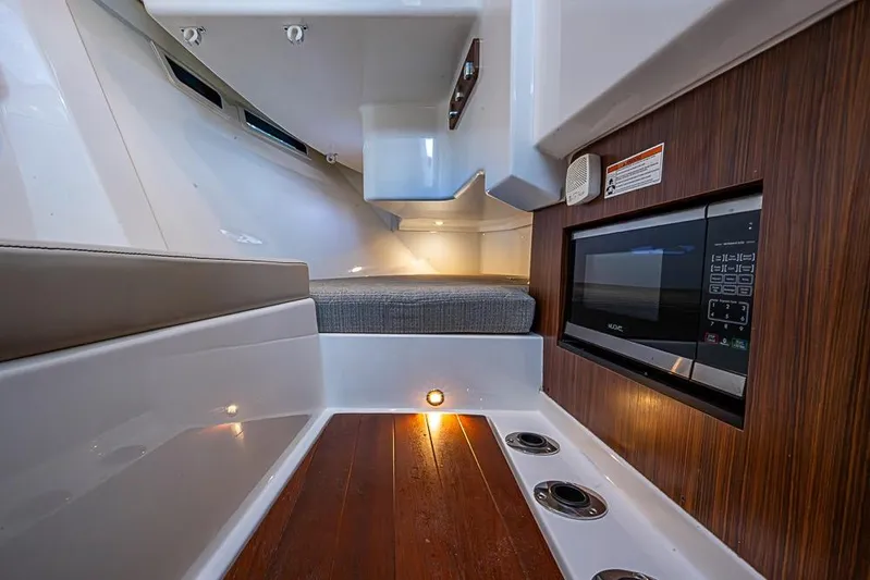  Yacht Photos Pics 2020 Pursuit DC 365 Dual Console interior with wood accents and built-in microwave.