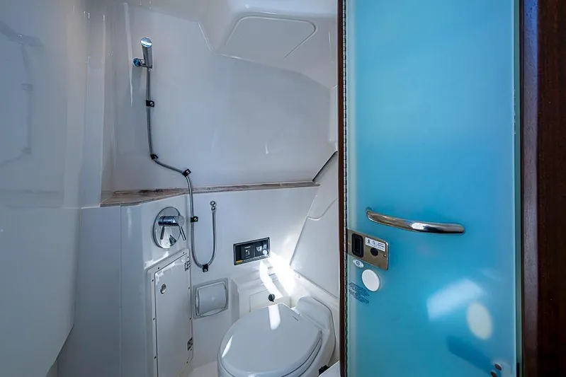  Yacht Photos Pics 2020 Pursuit DC 365 Dual Console boat bathroom with shower and toilet.