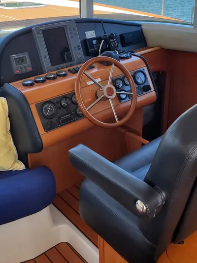 My Three Girls Yacht Photos Pics Interior helm of 2004 Lagoon 43 PC yacht with wooden steering wheel.