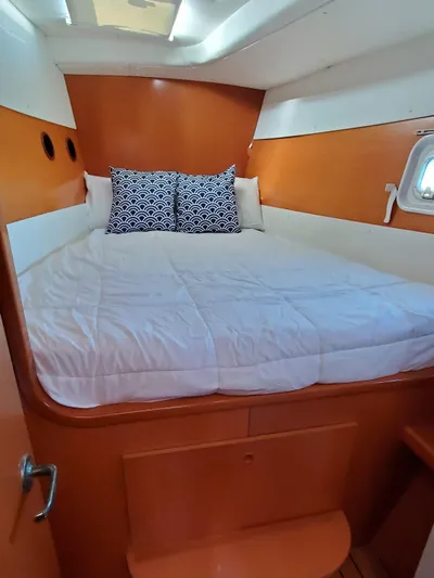 My Three Girls Yacht Photos Pics Cozy cabin interior of 2004 Lagoon 43 PC yacht with bed and pillows.