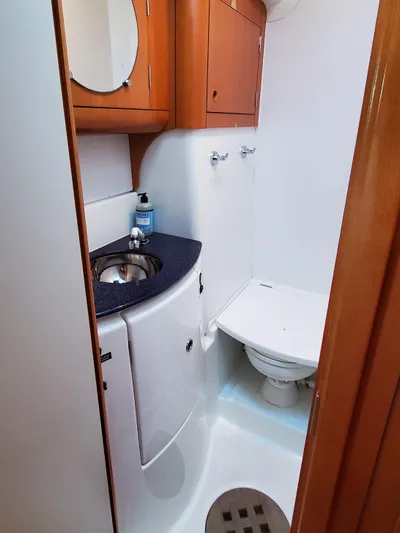 My Three Girls Yacht Photos Pics Compact bathroom in 2004 Lagoon 43 PC yacht with sink and toilet.