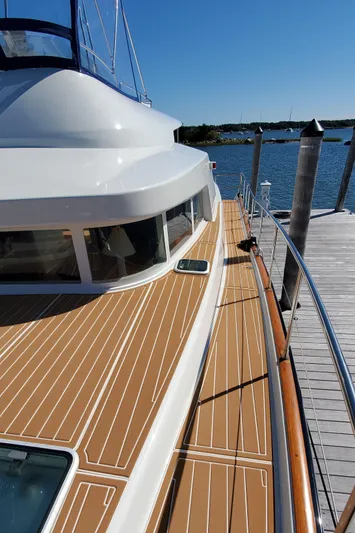 My Three Girls Yacht Photos Pics 2004 Lagoon 43 PC yacht with sleek deck design, docked by the water.